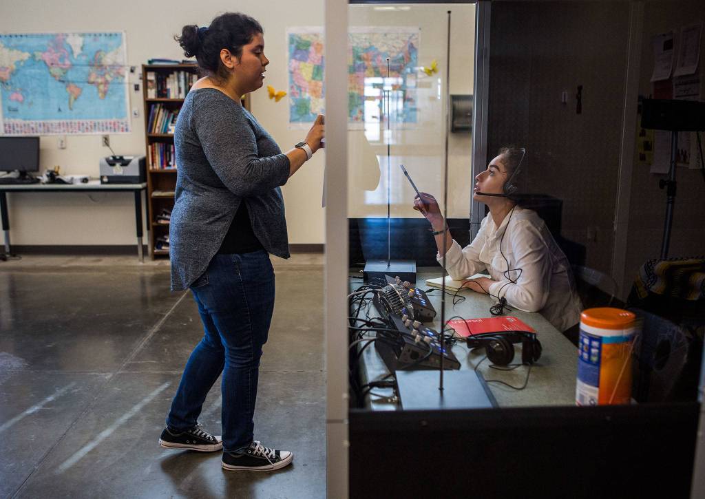 Sara Sandoval (left) and Kelly Leslie Medina-Bravo (right) go over what Medina-Bravo will be interpreting during the Fundamentals of Translation and Interpretation class at Sno-Isle Technical Skills Center on June 6 in Everett. (Olivia Vanni / The Herald)