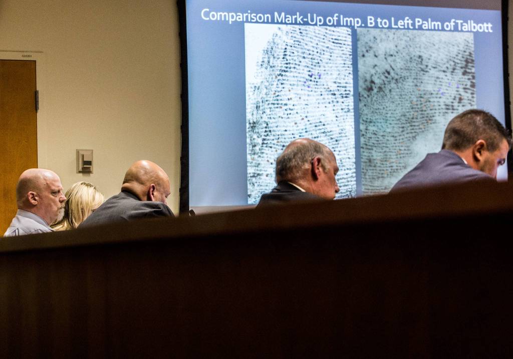 A powerpoint slide displays photos of two palm print comparisons that were analyzed by Washington State Patrol forensic scientist Angela Hilliard during the trial for William Talbott II at the Snohomish County Courthouse on Tuesday in Everett. (Olivia Vanni / The Herald)