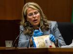 Lisa Collins, a forensic scientist with the Washington State Patrol, looks at a swab used to collect DNA from William Talbott II during the trial of William Talbott II at the Snohomish County Courthouse on Monday in Everett. (Olivia Vanni / The Herald)