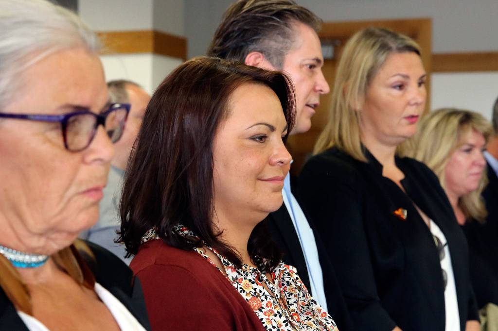 Family members of Jay Cook and Tanya Van Cuylenborg watch as William Talbott II is wheeled from the courthouse Friday morning at the Snohomish County Court House in Everett on June 28, 2019. Talbott was found guilty of all charges. (Kevin Clark / The Herald)