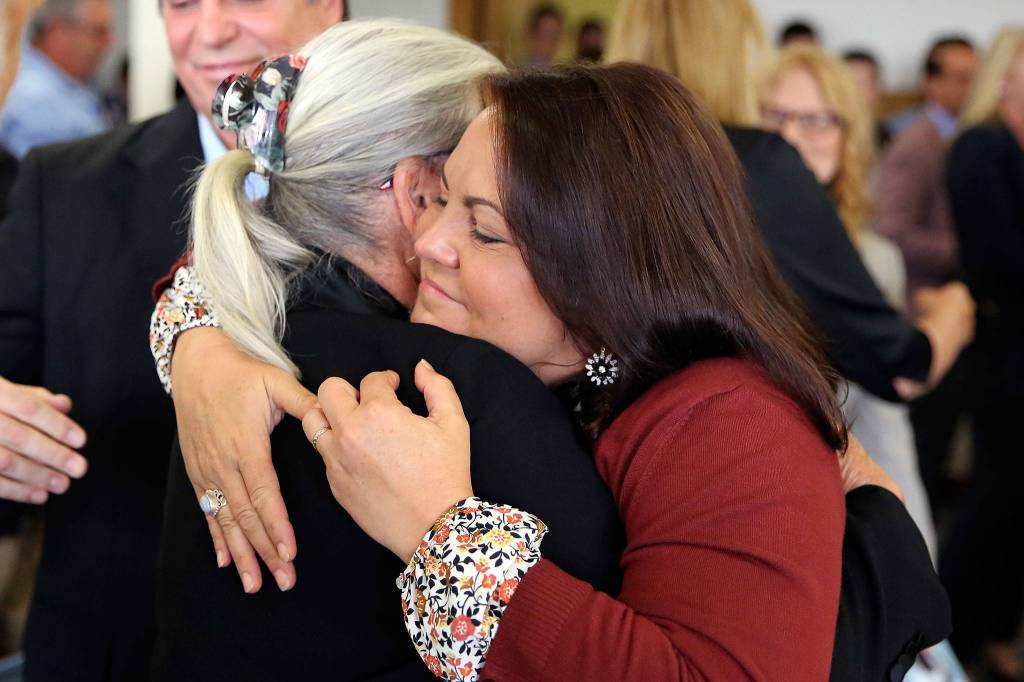 Lee Cook (left), mother of murder victim Jay Cook, hugs Laura Baanstra, Jay Cooks sister, after the guilty verdict of William Talbott II Friday at the Snohomish County Court House in Everett. (Kevin Clark / The Herald)