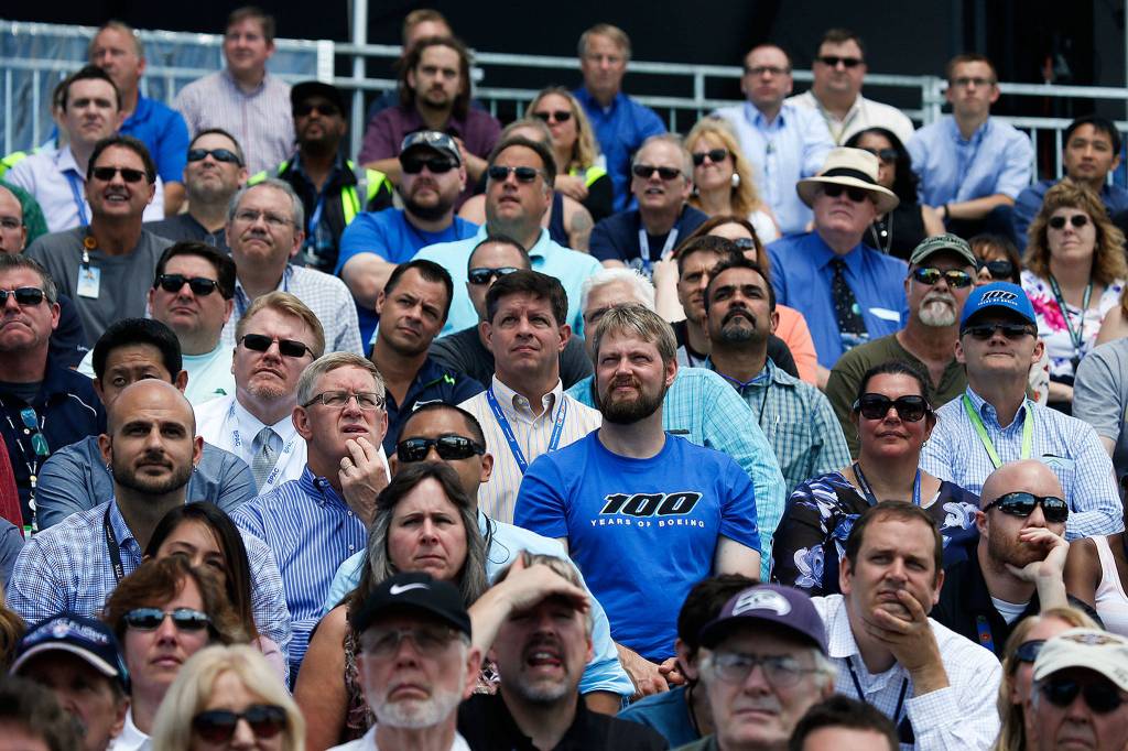 Wearing a Boeing 100th anniversary T-shirt, Everett employee Matt Carlsen stands among other workers and retirees at a centennial celebration at Boeing Field in Seattle in 2016. (Ian Terry / Herald file)