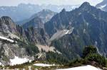 The view of east from Vesper Peak shows a climbers camp and Headlee Pass, at center, as well as the rugged terrain of the Glacier Peak Wilderness. (Caleb Hutton / The Herald)