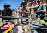 Volunteers gather on Wednesday to look at unique trash items found on the hill, ranging from full beers to a medical inhaler, during the annual trash cleanup at Stevens Pass. (Olivia Vanni / The Herald)