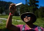 Sanjog Patel holds an old and faded ski pass he found during the annual Stevens Pass cleanup. (Olivia Vanni / The Herald)