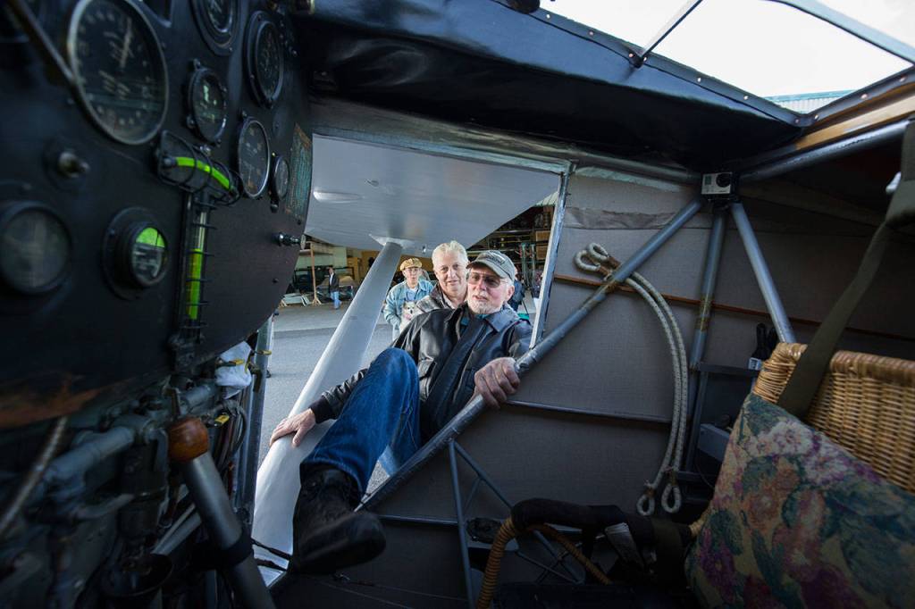 Getting into the cockpit is no easy feat as pilot Ron Fowler stretches a leg into John Normans replica of the Spirit of St. Louis before taking the plane out on its first flight July 28. (Andy Bronson / The Herald)