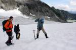 Researcher Ann Hill watches Mauri Pelto jam a metal pole into the snow to measure how deep it is. If its less than 8 feet deep it wont last the summer. (Zachariah Bryan / The Herald)