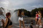 Girls take photos and dance next to the Seattle Center fountain during Bumbershoot Music & Arts Festival on Friday, Aug. 30, 2019 in Seattle, Wash. (Olivia Vanni / The Herald)