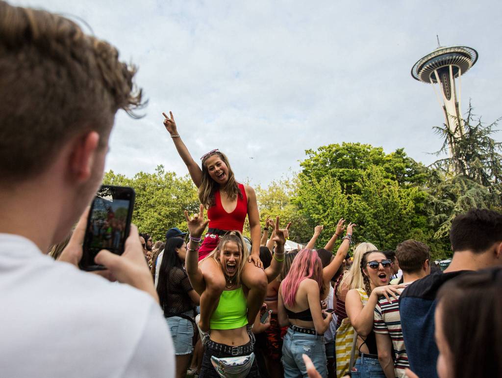 Two girls have their photo taken during Sols performance at Bumbershoot Music & Arts Festival on Friday, Aug. 30, 2019 in Seattle, Wash. (Olivia Vanni / The Herald)