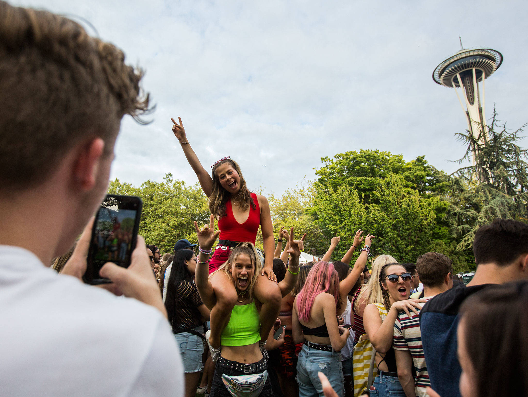 Two girls have their photo taken during Sols performance at Bumbershoot Music & Arts Festival on Friday, Aug. 30, 2019 in Seattle, Wash. (Olivia Vanni / The Herald)