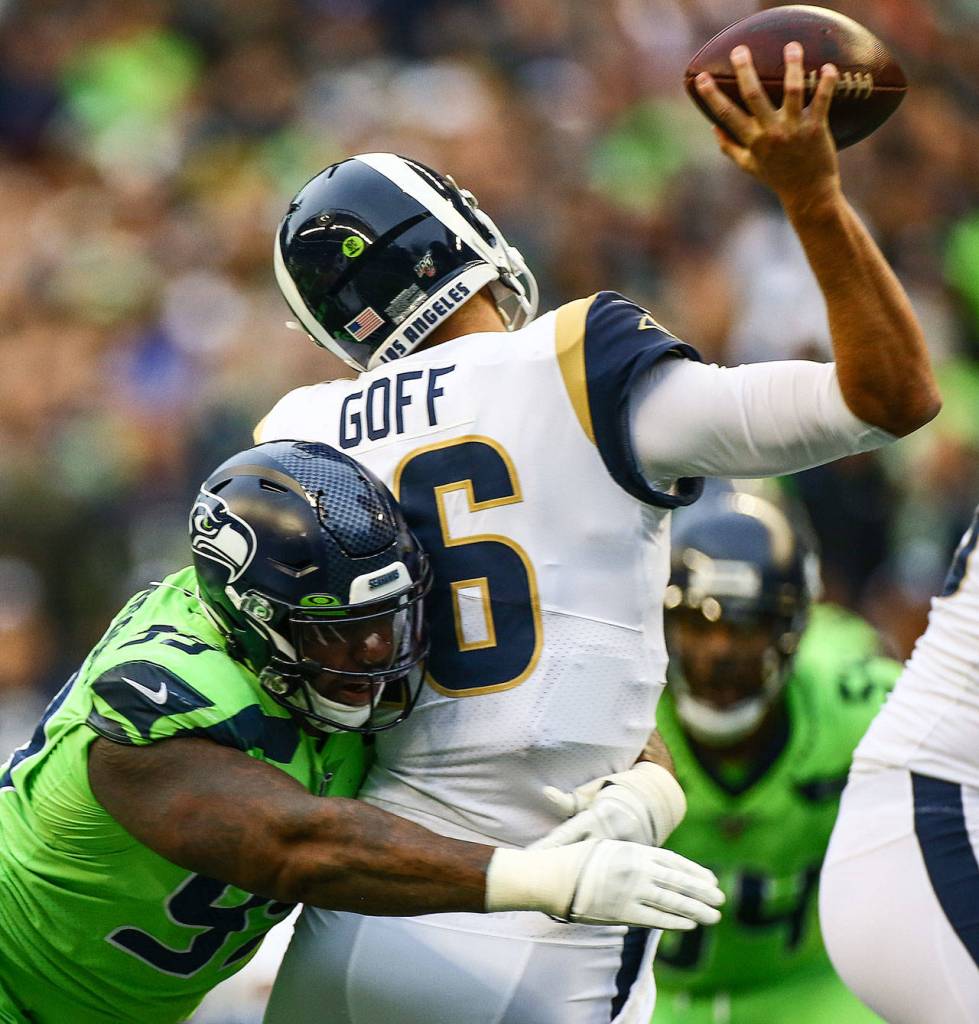 Seattles Quinton Jefferson (left) hits L.A. Rams quarterback Jared Goff as he attempts to throw a pass during the Seahawks 30-29 win over the Rams on Thursday at CenturyLink Field in Seattle.(Kevin Clark / The Herald)