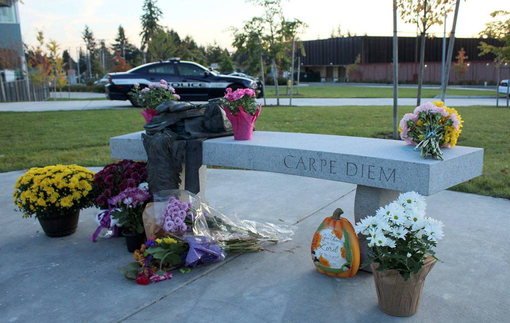 Memorial attendees brought bouquets of flowers to Sarah Yarboroughs memorial bench on Oct. 11. Olivia Sullivan/staff photo