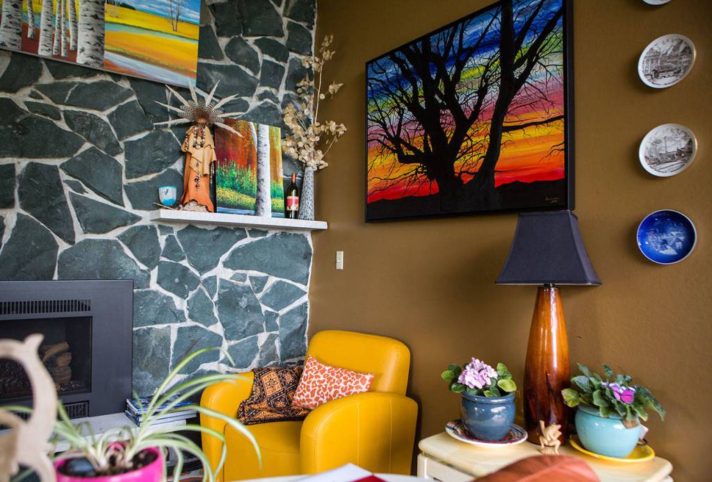 Lee Oskars paintings hang on display in his home in Everett. (Olivia Vanni / The Herald)