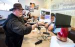 Michael W. Hall, who heads a group called the UFOiTeam, shows photos of an unidentified flying object to a live stream audience during a meeting in 2018. (Andy Bronson / The Herald)