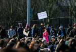 A young girl holds up a Dont Pollute I Live Here sign in the crowd during the Youth Climate Strike at Cal Anderson Park on Friday, March 15, 2019 in Seattle, Wash. (Olivia Vanni / The Herald)