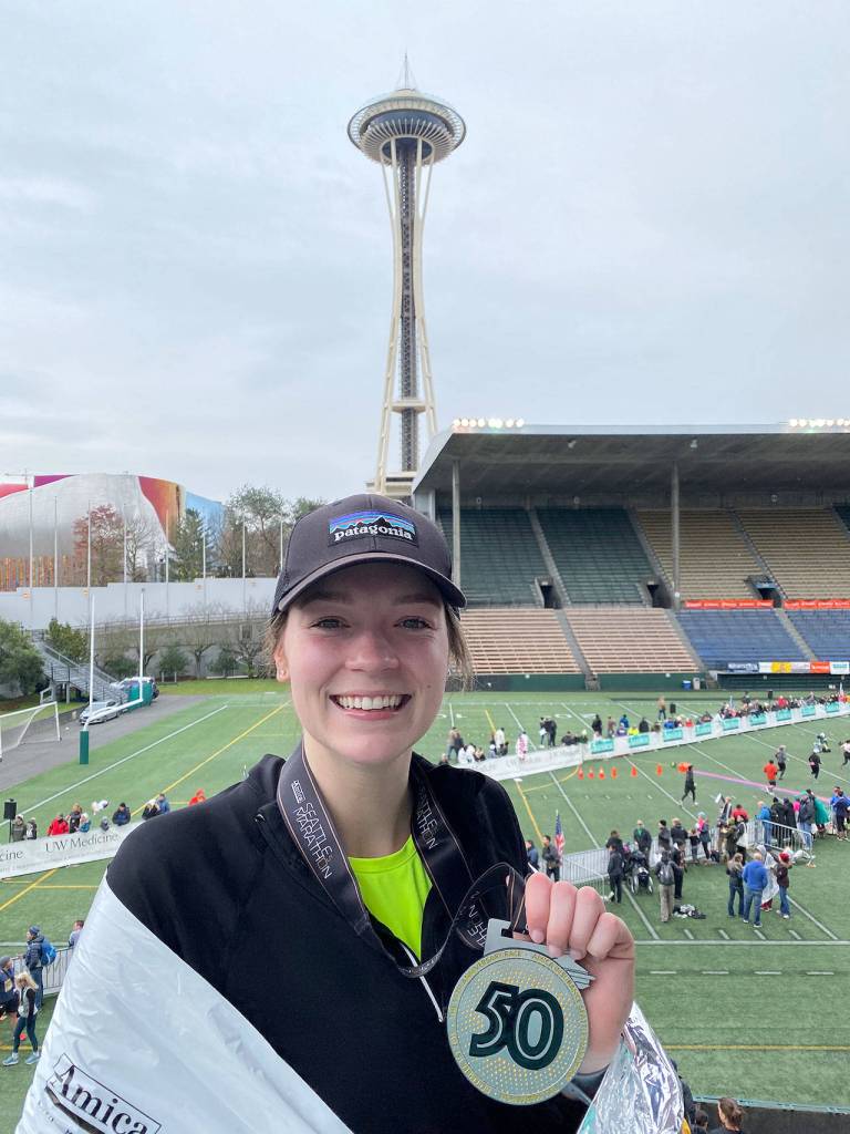 Mirror reporter Olivia Sullivan holds the Seattle Marathon 50th Anniversary medal after completing the half marathon race on Sunday, Dec. 1. Courtesy photo