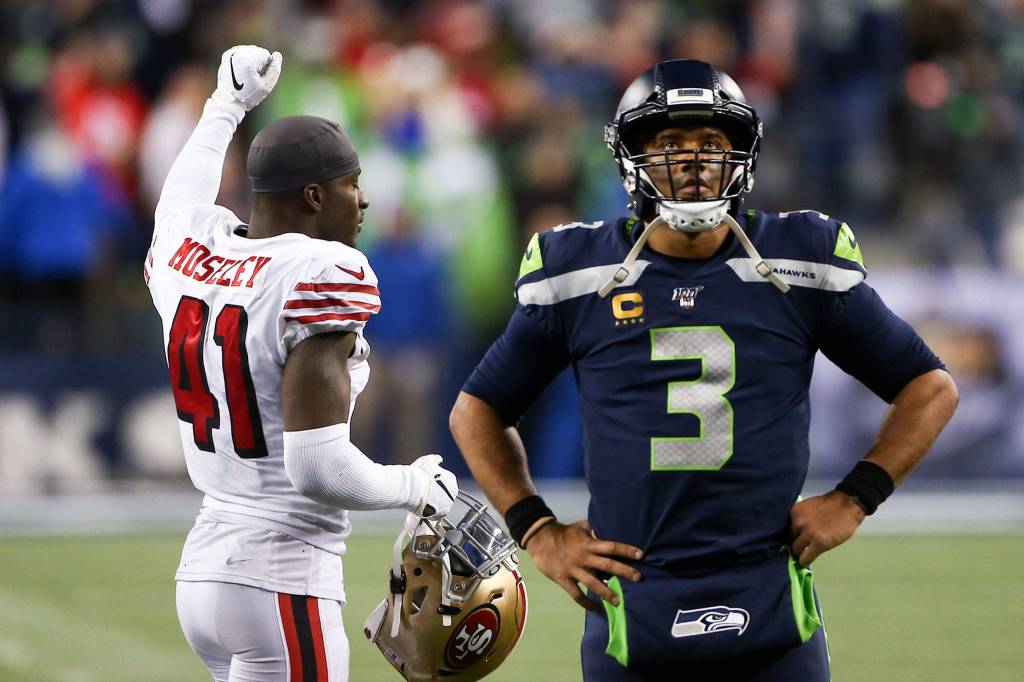 Seattle Seahawks Russell Wilson watches the replay as San Franciscos Emmanuel Moseley celebrates the 49ers win, 26-21, Sunday evening at CenturyLink Field in Seattle on December 29, 2019. (Kevin Clark / The Herald)