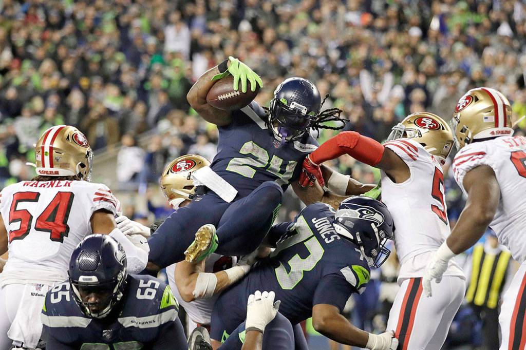 Seahawks running back Marshawn Lynch (24) scores a touchdown on a 1-yard run during the second half of Sundays game in Seattle. (AP Photo/Stephen Brashear)