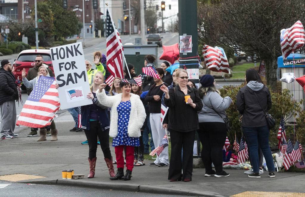 Samiu Bloomfields friends and fans gather on Broadway to honor him Monday in Everett. (Andy Bronson / The Herald)