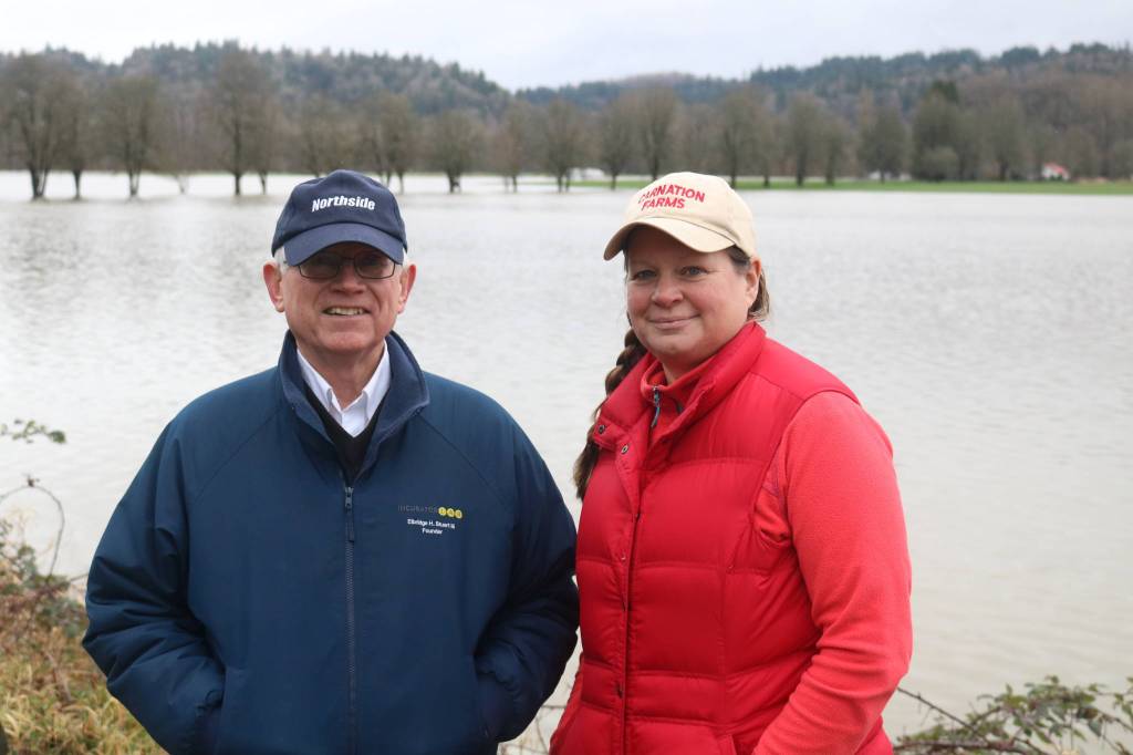 Elbridge Stuart and Rosy Smit stand in front of Carnation Farms flooded fields on Feb. 7, 2020. Its the fifth flood this year along the Snoqualmie River that has broken 56 feet. Aaron Kunkler/staff photo