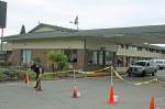 A security guard positions cones as he stands watch in front of the Econo Lodge-turned-coronavirus-quarantine site on Central Avenue North on Tuesday. King County personnel were on site preparing the motels transformation into an isolation/quarantine center. MARK KLAAS, Kent Reporter