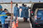 Drive-thru COVID-19 virus testing last week in the parking lot near Everett Memorial Stadium in Everett. A study by the University of Washington and UnitedHealth Group, conducted at Everett Clinic locations, found that a less-intrusive form of the coronavirus test would require fewer precautions by health care workers. (Andy Bronson / The Herald)