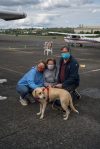 Niaya with her new family meet for the first time at Renton Municipal Airport. The labrador-beagle mix travelled thousands of miles to meet her new family in the midst of the coronavirus pandemic. Photo by Andre Osorio/For the Renton Reporter