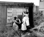The Washington Equal Suffrage Association places posters in Seattle in 1910 to promote womens suffrage. (Washington State Archives)