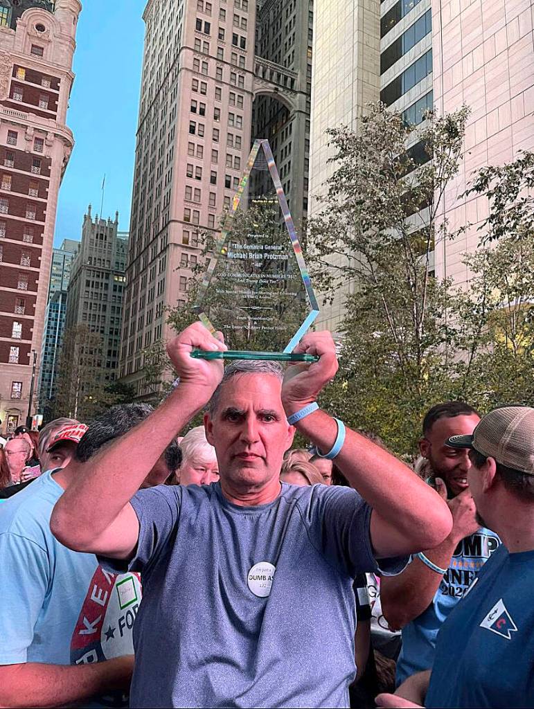 Michael Brian Protzman holds a trophy on Nov. 1. Photo via Protzmans Negative48 Telegram channel