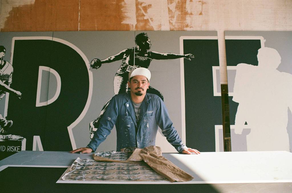 Alexander Codd poses in front of the Liberty Park mural (photo by Andrew Valentine)