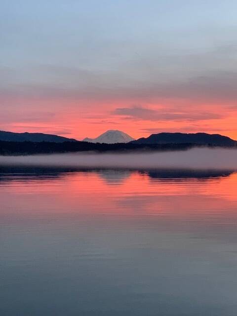Photo courtesy of Abbie Crane, who writes that on Jan. 12, 2022, "I walked on the East Lake Sammamish Trail at about 4:30 p.m. The combination of a colorful, beautiful sunset and a bank of fog on the lake made these pictures very special. Mt. Rainier made an appearance."