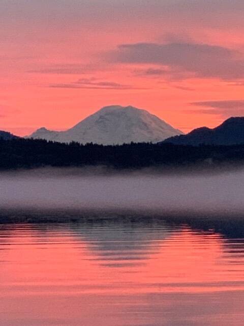 Photo courtesy of Abbie Crane, who writes that on Jan. 12, 2022, I walked on the East Lake Sammamish Trail at about 4:30 p.m. The combination of a colorful, beautiful sunset and a bank of fog on the lake made these pictures very special. Mt. Rainier made an appearance.