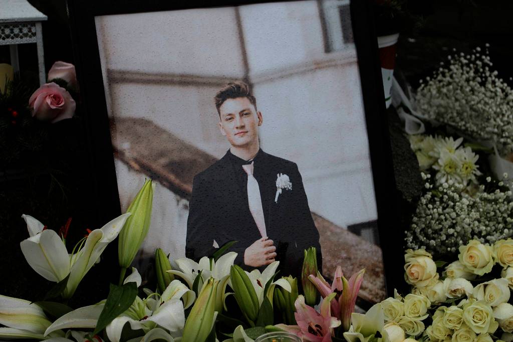Raindrops cover a photo of Ruvim Stukov, surrounded by flowers in Federal Way. Olivia Sullivan/the Mirror