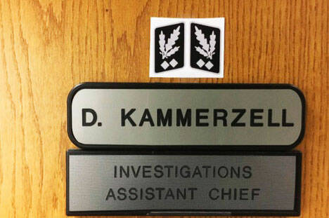 A screenshot from an investigators report about the Nazi symbol Kent Police Assistant Chief Derek Kammerzell placed above his nameplate on his office door.