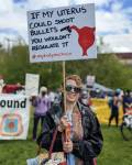 A woman smiles while holding a sign at the Cal Anderson Park reproductive rights protest on May 14, 2022. Hannah Saunders/Sound Publishing