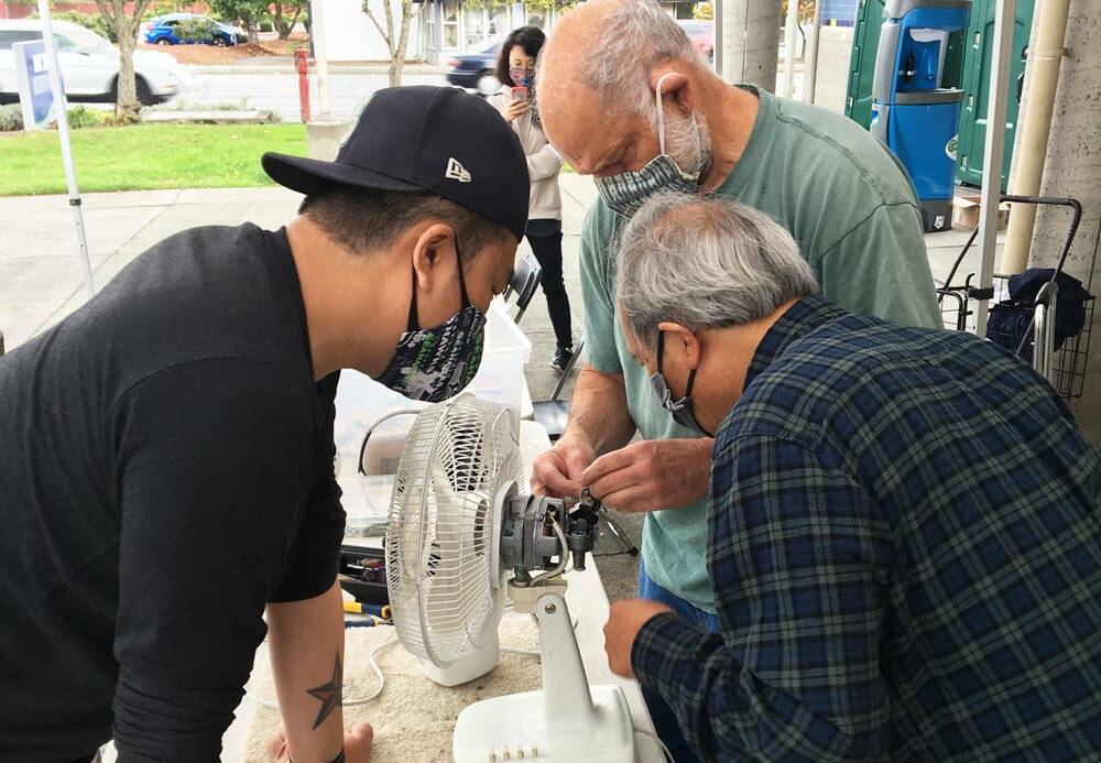Photo courtesy of King County Solid Waste Division
Volunteer fixers attempt to repair a fan at one of King Countys 2021 repair events.