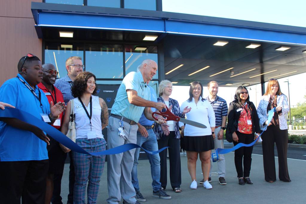 Renton Mayor Armondo Pavone and several members of the Renton City Council accompany Topgolf Renton Director of Operations Paul Howard for the ribbon-cutting ceremony. Photo by Bailey Jo Josie/Sound Publishing