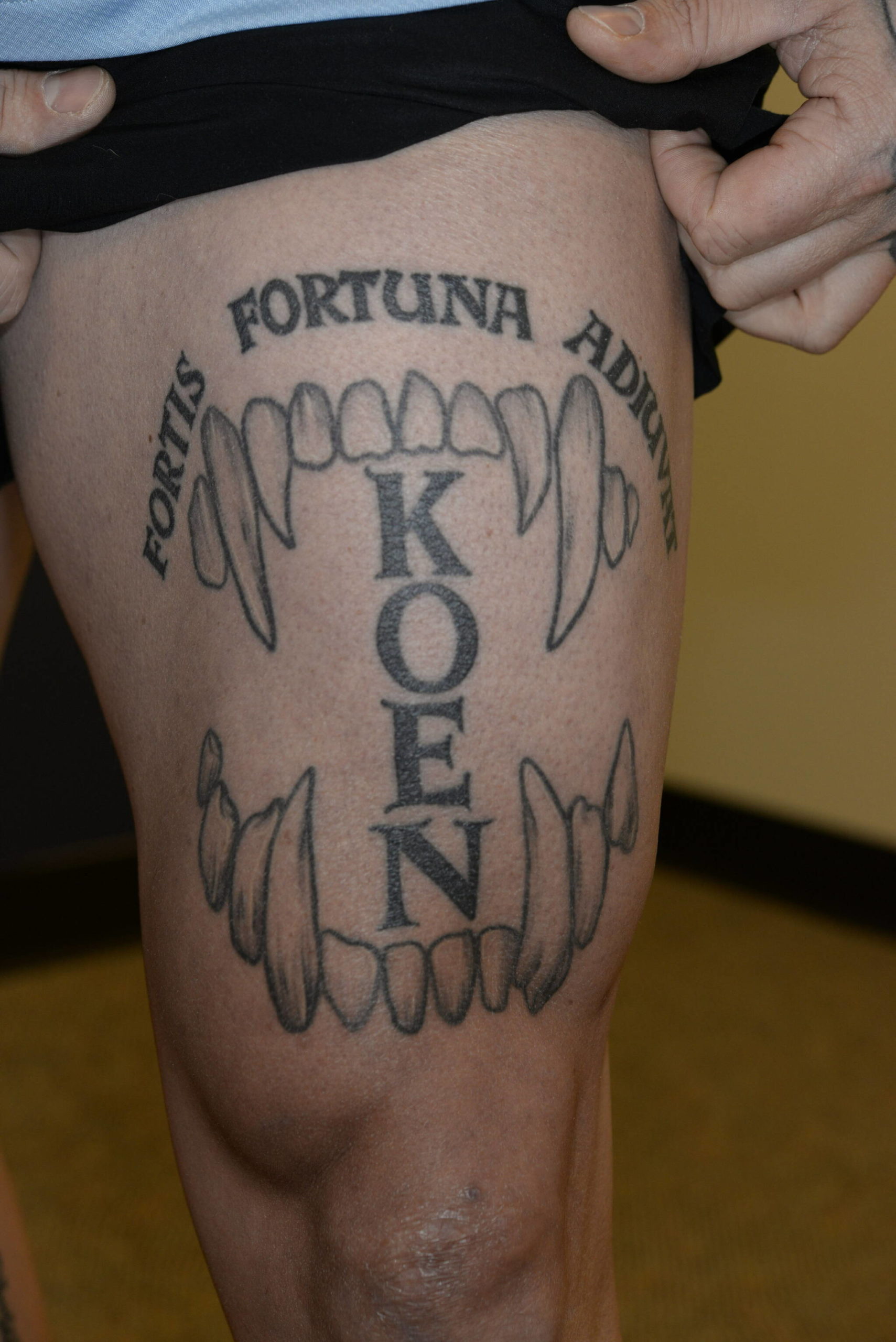 Photo of Nelsons thigh shows a tattoo of Jeff Nelsons Auburn Police K9s name Koen set in between canine teeth and a Latin phrase which translates to fortune favors the bold. These photos were taken by the FBI after Nelson was charged with murder. Courtesy photo