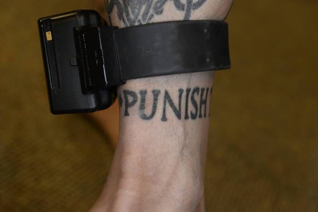 Nelsons ankle tattoo reads punish the deserving. These photos were taken by the FBI after Nelson was charged with murder. Courtesy photo