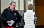 Mike Raughter, a union representative with the Marysville Albertsons, hands a leaflet to a shopper during an informational campaign on Wednesday. Raughter was one of less than a dozen grocery store workers handing out leaflets to shoppers about the proposed merger between Albertsons and Kroger. (Mike Henneke / The Herald)