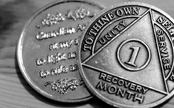 One persons month recovery coins after battling a fentanyl addiction. (Kevin Clark / The Herald)