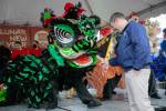 Photo by Ryan Berry / The Herald
Edmonds Mayor Mike Nelson rewards a lion dancer with a traditional red envelope during a celebration of the Lunar New Year on Saturday, Jan. 21, 2023.