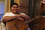 Alex Bruell / The Mirror
Decatur High School senior and American Idol contestant Iam Tongi sits at home on March 1. His father Rodney spent a bonus from his job as an electrician to buy Iams guitar.