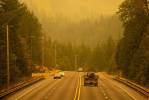 An emergency fire vehicle heads past a barricade and towards Index as numerous agencies attempt to contain the Bolt Creek Fire on Saturday, Sep. 10, 2022, on U.S. Highway 2 near Index, Washington. (Ryan Berry / The Herald)