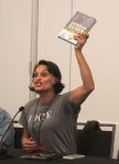 Writer Olivia Cuartero-Briggs holds up Gender Queer: A Memoir by Maia Kobabe, the most banned book in the United States, during an ECCC 2024 panel about banned books. Photo by Bailey Jo Josie/Sound Publishing