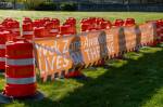 Sixty-one orange traffic barrels were set up April 2, 2024, on the WSDOT front lawn in Olympia. Each cone represents a fallen WSDOT employee killed on the job since 1950 - many in active work zones. The visual display is meant to remind everyone of the importance of slowing down in work zones. Photo courtesy of Washington State Department of Transportation.