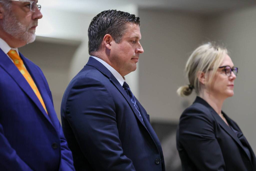 Auburn Police Officer Jeffrey Nelson, flanked by attorneys, stands as two guilty verdicts are handed down Thursday, June 27, 2024, at the King County Maleng Regional Justice Center in Kent. (Ken Lambert / The Seattle Times / Pool)