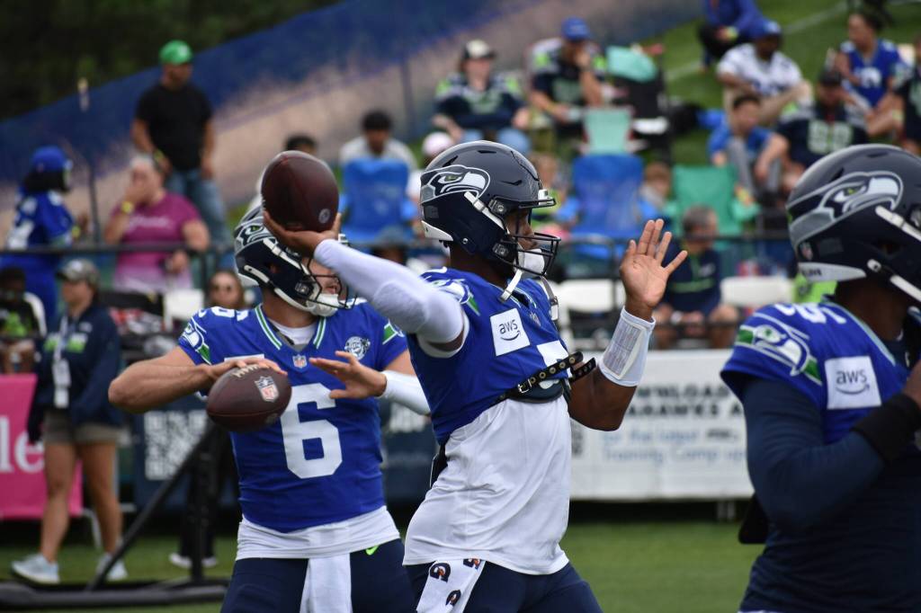 All three quarterbacks getting loose, with Seahawks starter Geno Smith front and center. Photos by Ben Ray / Sound Publishing