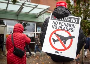 Larry Best, a customer coordinator for quality assurance who has worked at Boeing for 38 years, stands outside of Angel of the Winds Arena with a vote no sign on Monday in Everett. (Olivia Vanni / The Herald)