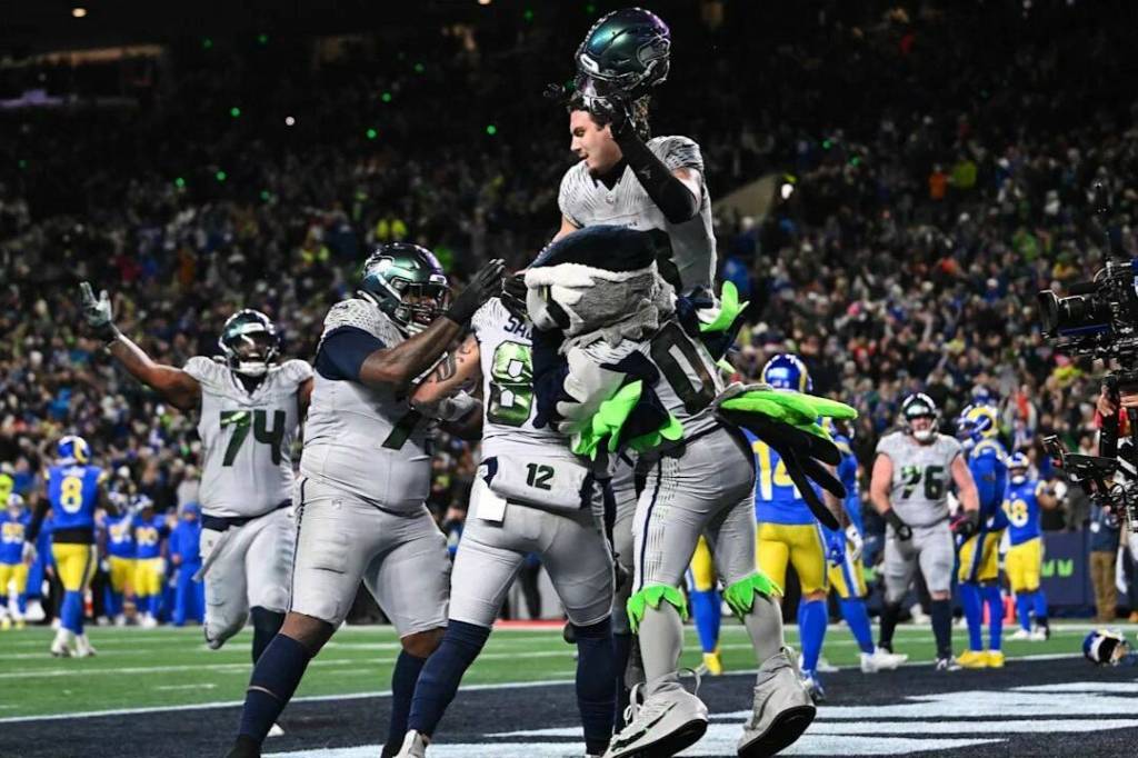 Seattle Seahawks tight end Eric Saubert is lifted up by his teammates after scoring the game-winning 2-point conversion against the Los Angeles Rams on Thursday, Dec. 18, at Lumen Field in Seattle. (Photo courtesy of the Seattle Seahawks)